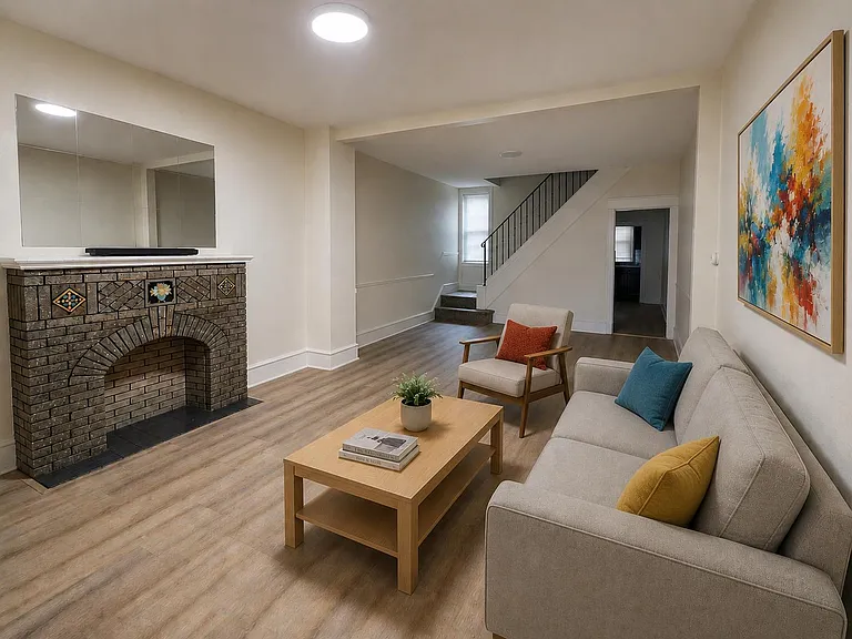 Open living room with wood-look flooring, decorative fireplace, and a comfortable seating area with easy flow to the stairs.
