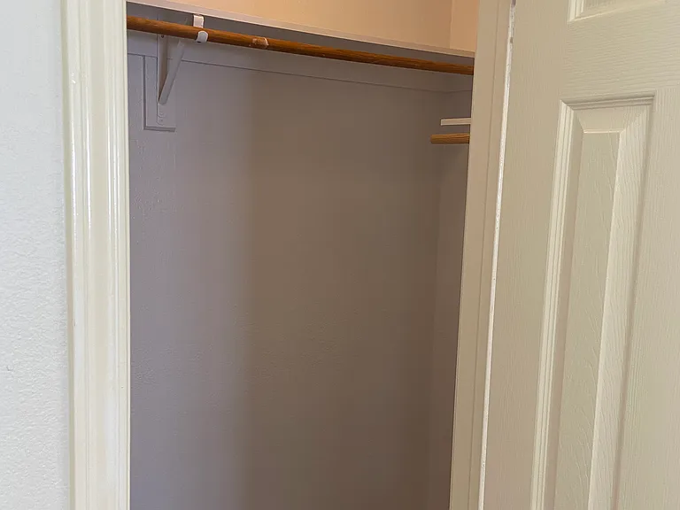 One of two primary walk-in closets.
