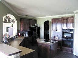 Large island Kitchen with double ovens opens to family room