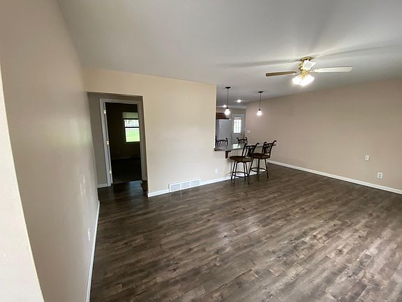Living room with 4 person bar area for eating.