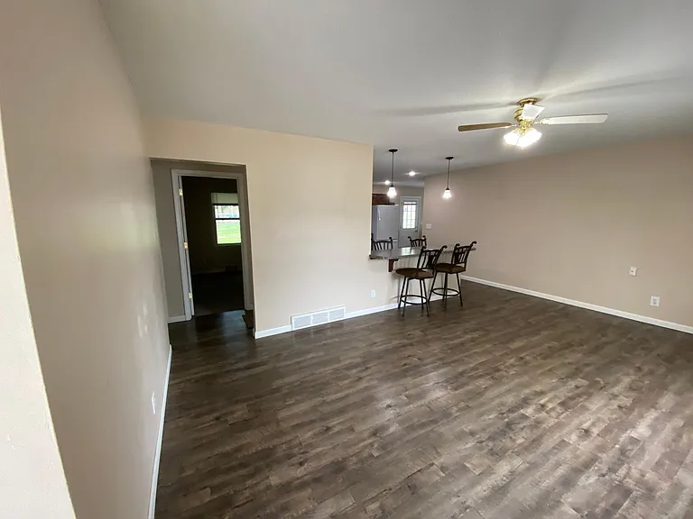 Living room with 4 person bar area for eating.