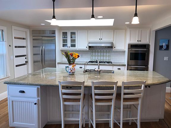 Kitchen is brightened by large skylight, large island