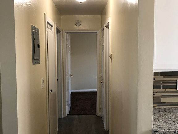Hallway with light, linen closet leading to master bedroom and third bedroom.