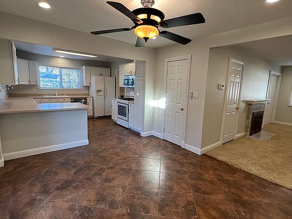 Dining area looking into kitchen and living room