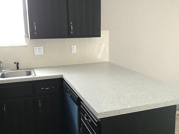 Spacious Kitchen is immaculate with black/stainless applianc