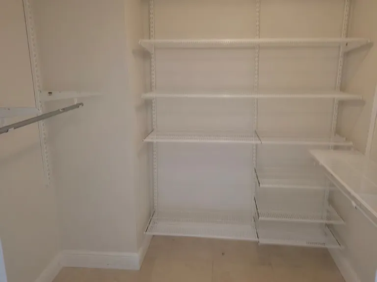 Master Bedroom walk in closet with built in shelving from container store