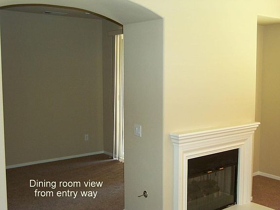 dining area and gas fireplace as seen from entry