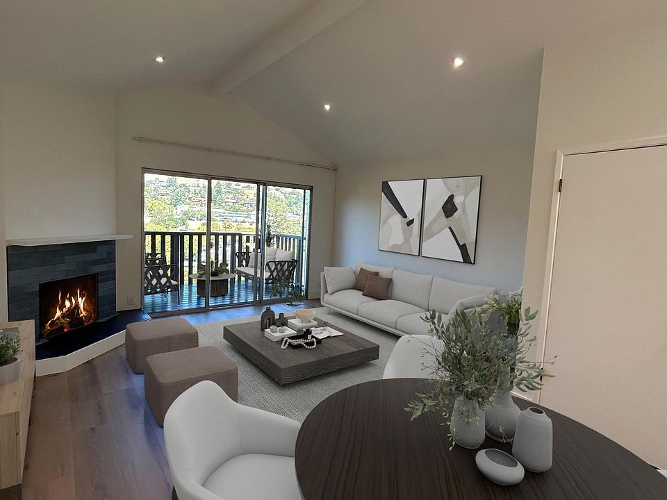 Open concept living and entertaining area with cathetral ceiling and wood burning fire place