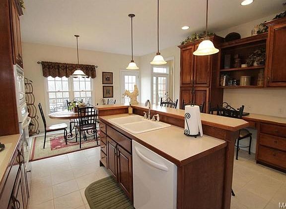 Bright kitchen opens to deck and view of the woods.