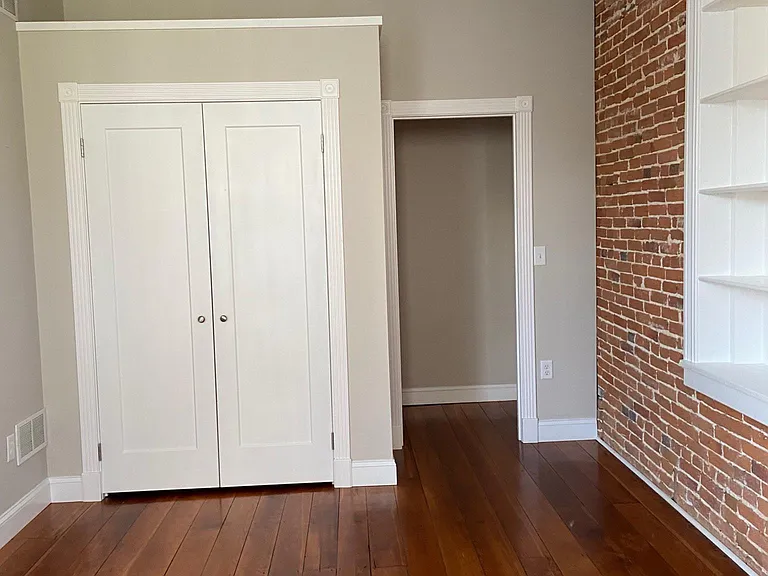 1st room closet showing built in shelves