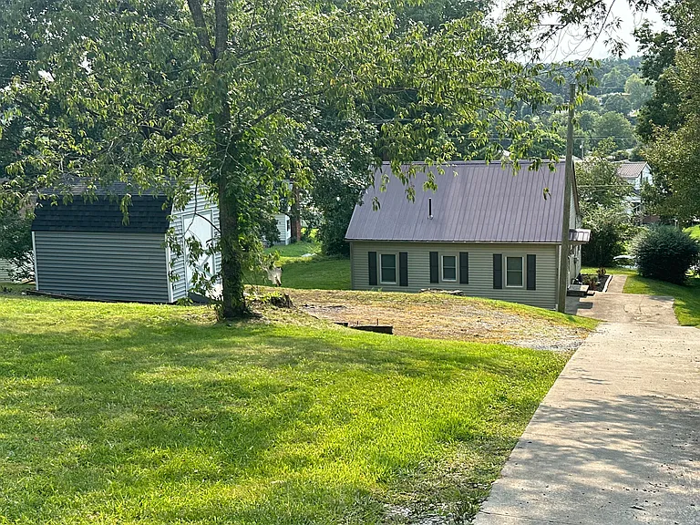 Driveway side of house. Driveway is on Redbud Dr
