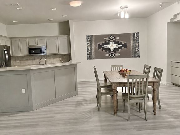 DINING/LIVING Room is staged with horizontal Indian blanket.