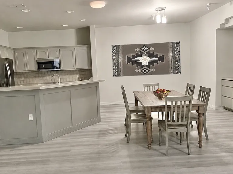DINING/LIVING Room is staged with horizontal Indian blanket.
