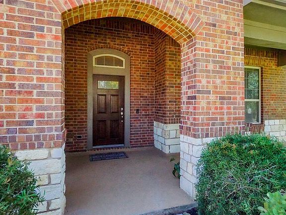 Enjoy Your Grand Entry with a Beautiful Archway and a Lovely Covered Patio Perfect for Rocking Chairs or a Swinging Bench!