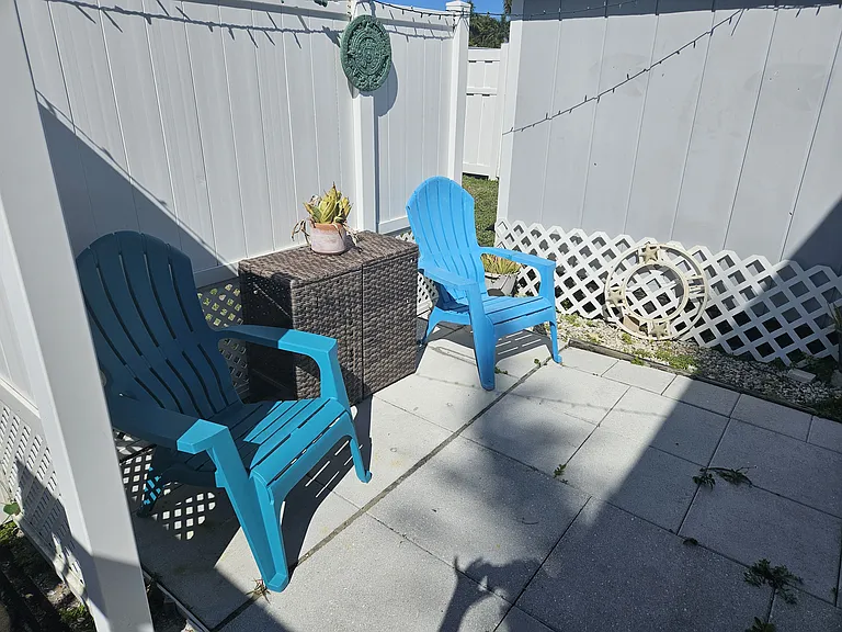 Back patio side of house with grill other side