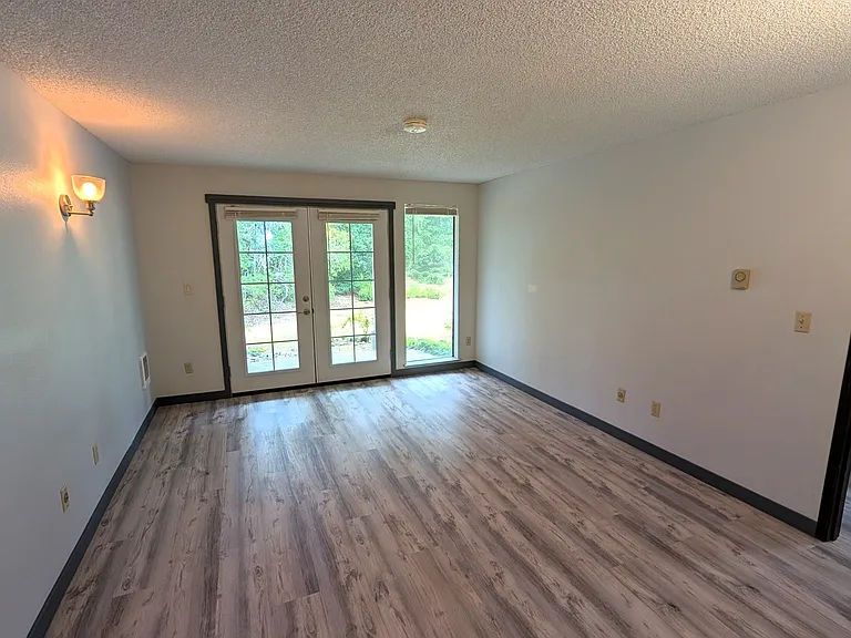 Primary bedroom, features French doors to private patio