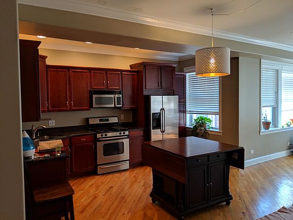 Kitchen island with 6 chairs comes part of rental - ends of table flip up and down to use when you need the space.