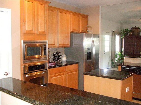   Another view of the kitchen which is open to the family room and the breakfast area.