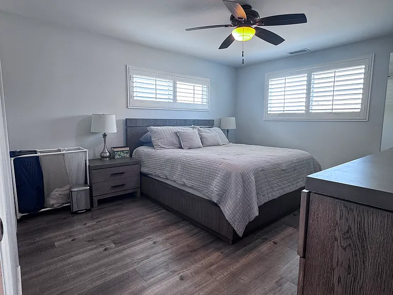 The primary bedroom is 14x14, shutters on the windows, ceiling fan and access to the master bathroom.