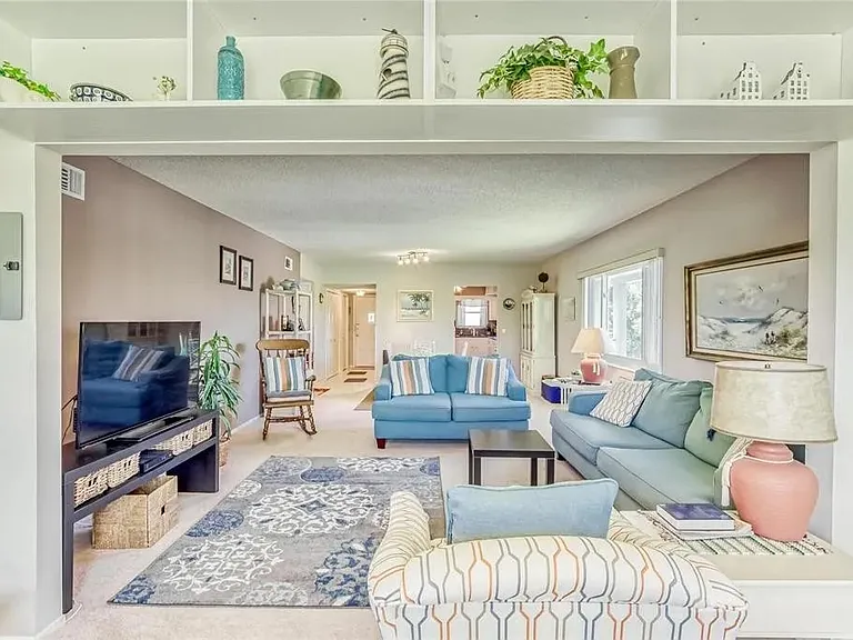 View of the living room from the Florida room.

 *This unit is unfurnished. All furniture has been removed.