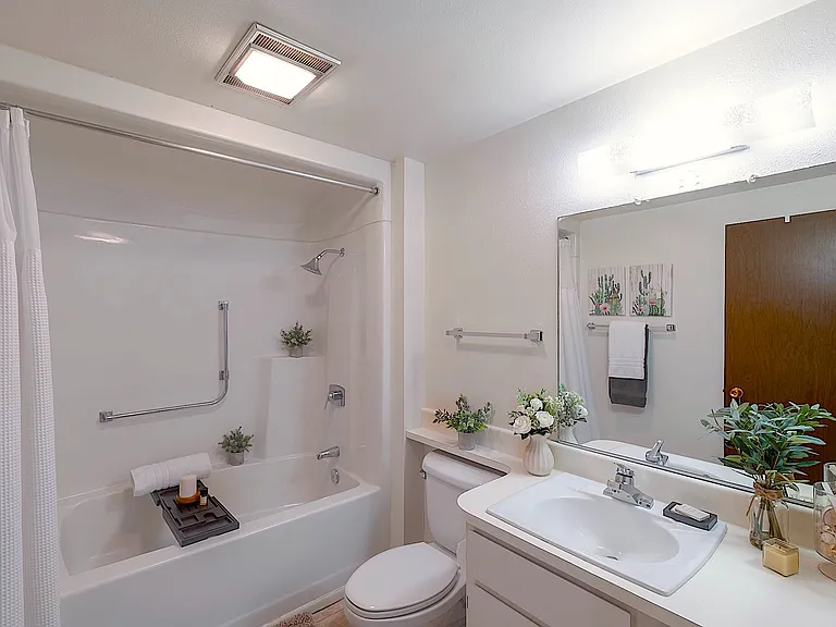 Guest bathroom with large bathtub, shower & bench
