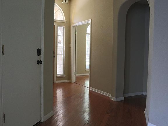 View looking towards front door and door into garage