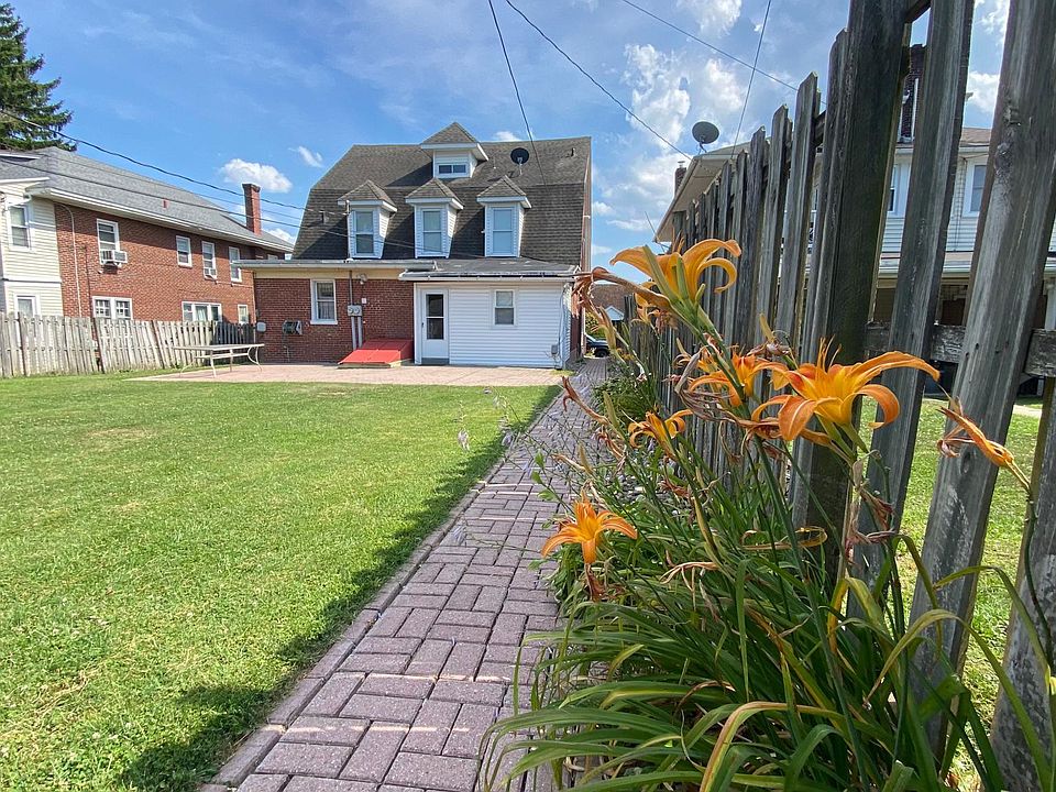 Exterior rear with walkway and large backyard.