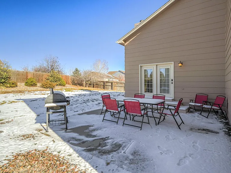 Fully fenced in yard with plenty of seating and a grill!