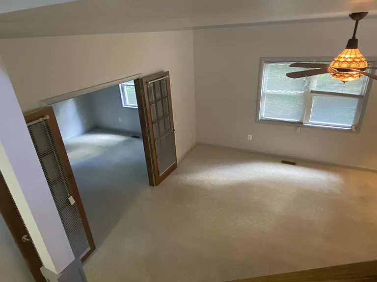 Living room with French doors leading to den.