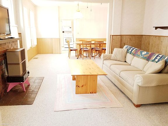 living and dining rooms with view of kitchen