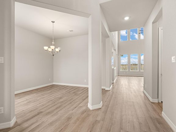 Entryway and formal dining room. Note Sample product photo - actual exterior and interior selection