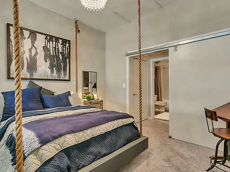 Large bedroom with carpet and barn door