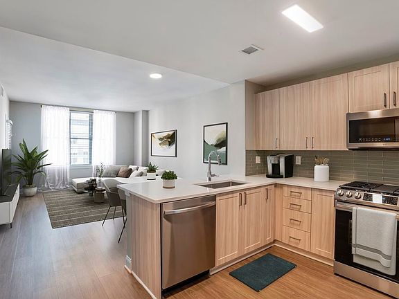 Renovated Package II kitchen and living room with hard surface flooring