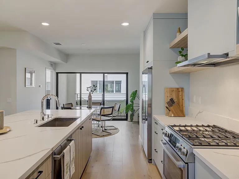 Modern kitchen designed for both everyday living and entertaining, featuring Bosch appliances, quartz countertops, generous storage, and an oversized center island.
