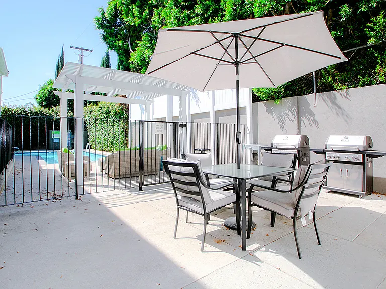 Courtyard barbecue and seating area with umbrella.