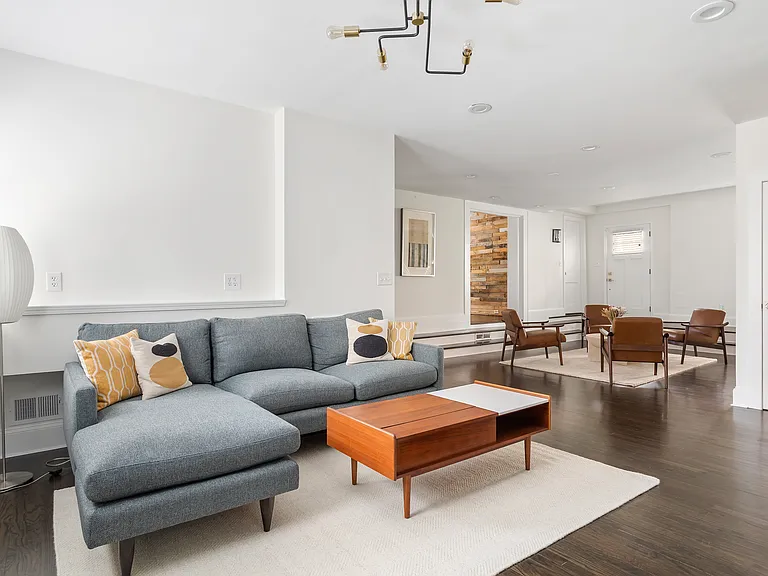 Main living room with fireplace and TV. New, comfortable sofa, and coffee table top lifts up for dining, scrolling, or working.