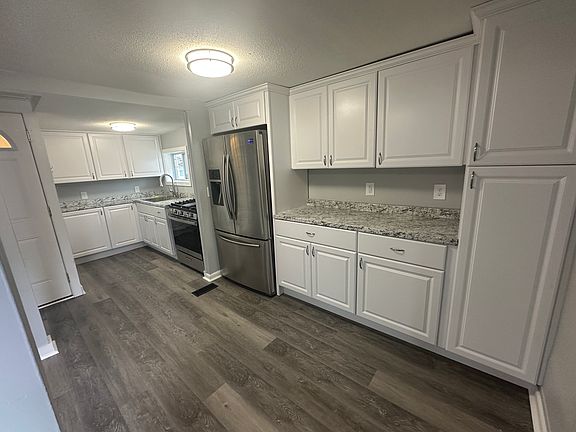 Another view of the kitchen highlighting the bright, open layout and ample counter space.