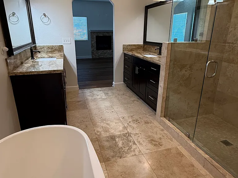 Primary bathroom with bathtub, shower and his-and-hers sinks