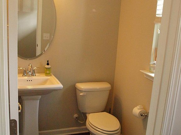 downstairs powder room off of front foyer entry.