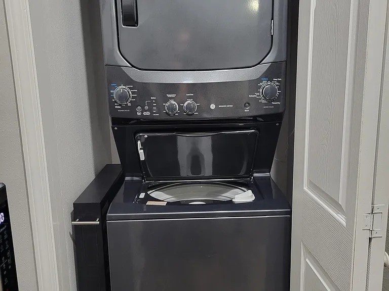 Stackable washer and dryer with rollout small side storage