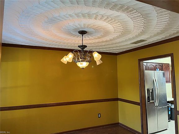 Formal dining room with swirled ceiling.