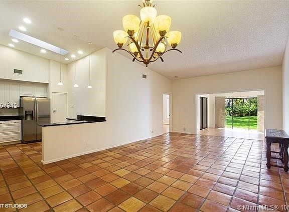 Open floor plan, high ceilings, garden view with the pool behind it