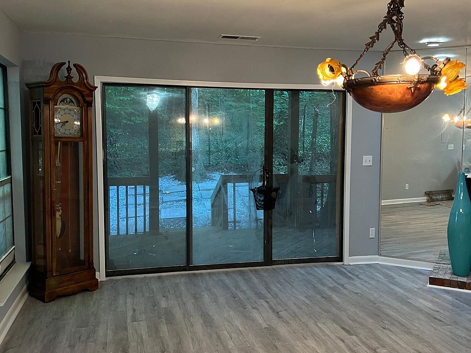 Large family room with fireplace facing to a manicure yard with burn fire pit.