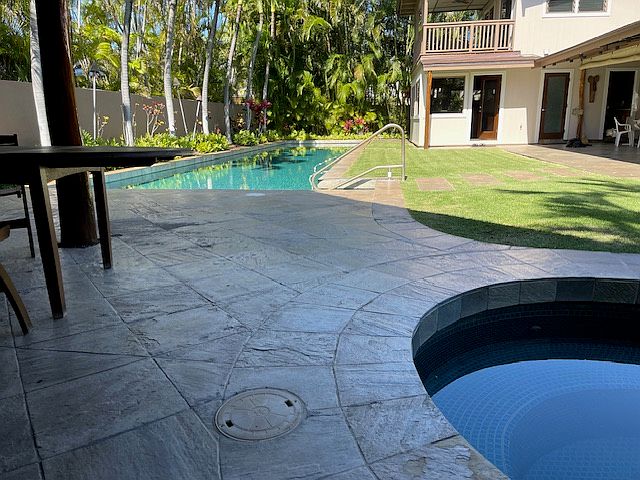 Backyard view of house, rental unit, pool/jacuzzi.