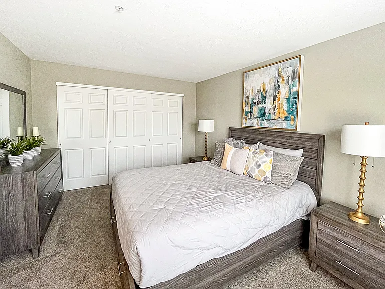 Spacious 1st-floor bedroom with large closet and plush carpeting
