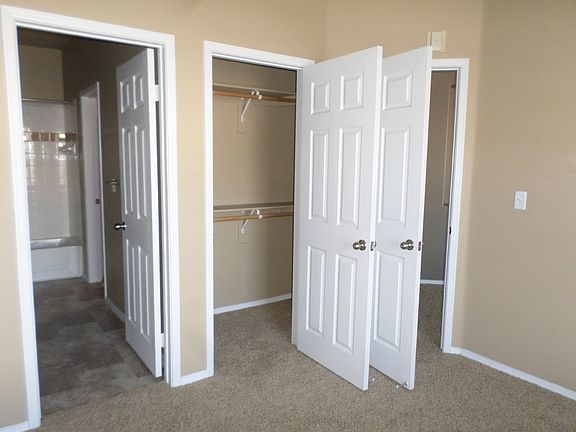 walk in closets and ceiling fans in both bedrooms