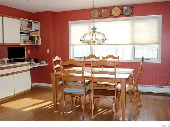 Enormous kitchen with desk and dining area.