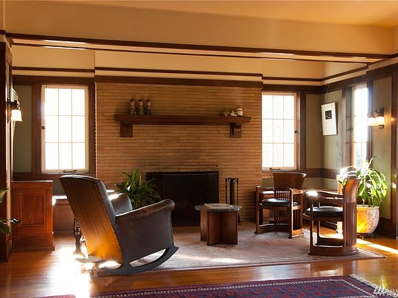 A pair of window seats, the original fireplace and ancient Russian Oak for floors and Prairie-style trim are integral to the soothing design. The serene yet spectacular covered porch is to the right of this view.