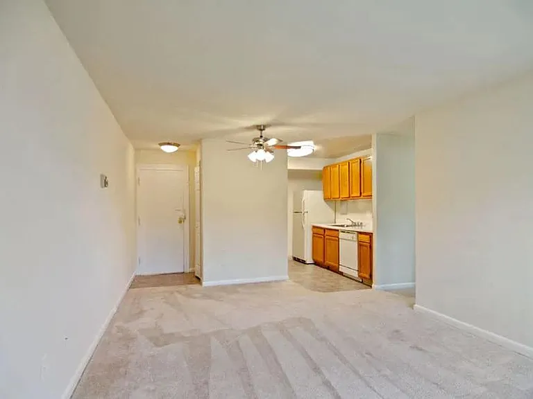 View of living area, kitchen, and entrance at Broadfalls in Falls Church, VA
