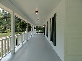 There's a 608 sq. ft. wrap around covered porch inviting magnificiantly peaceful views from three si